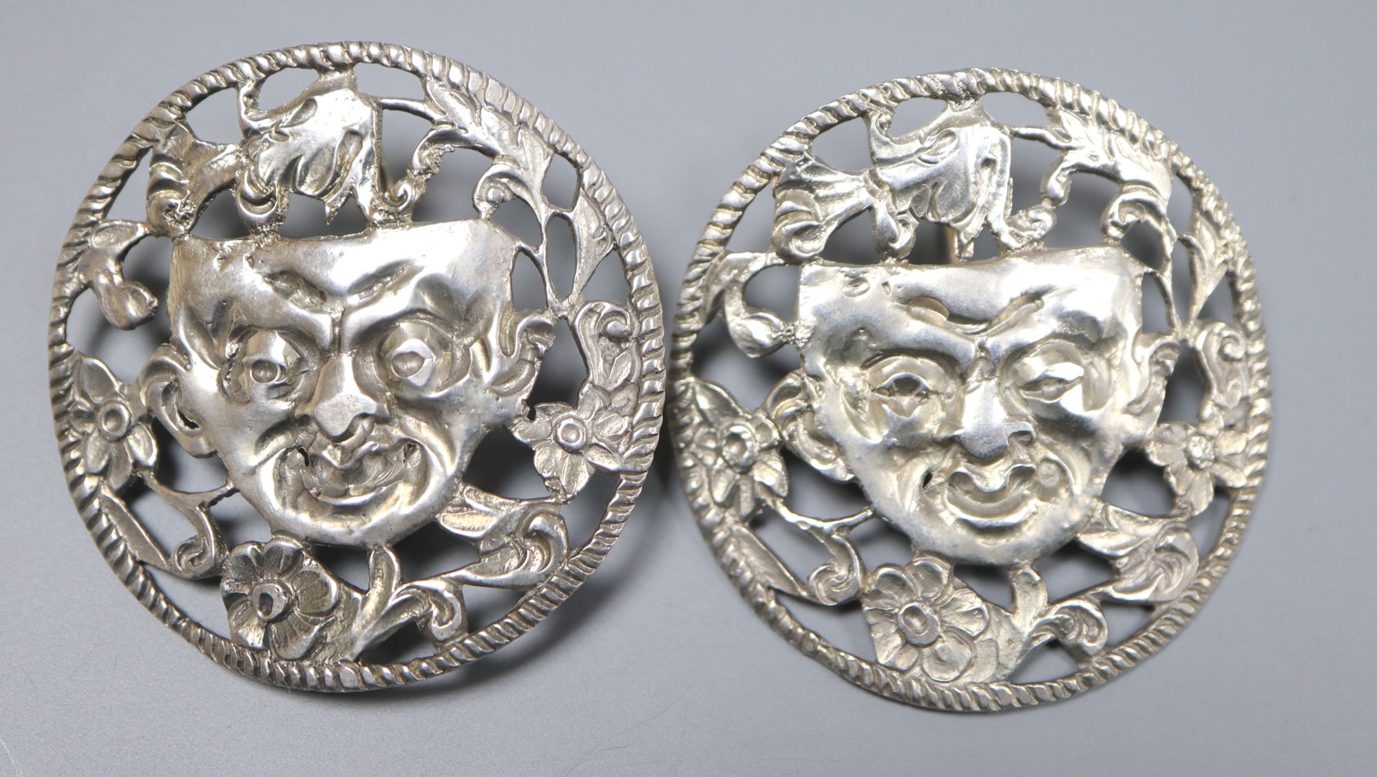 A pair of continental pierced white metal foliate and mask concave circular earrings, 38mm, gross 14.5 grams.